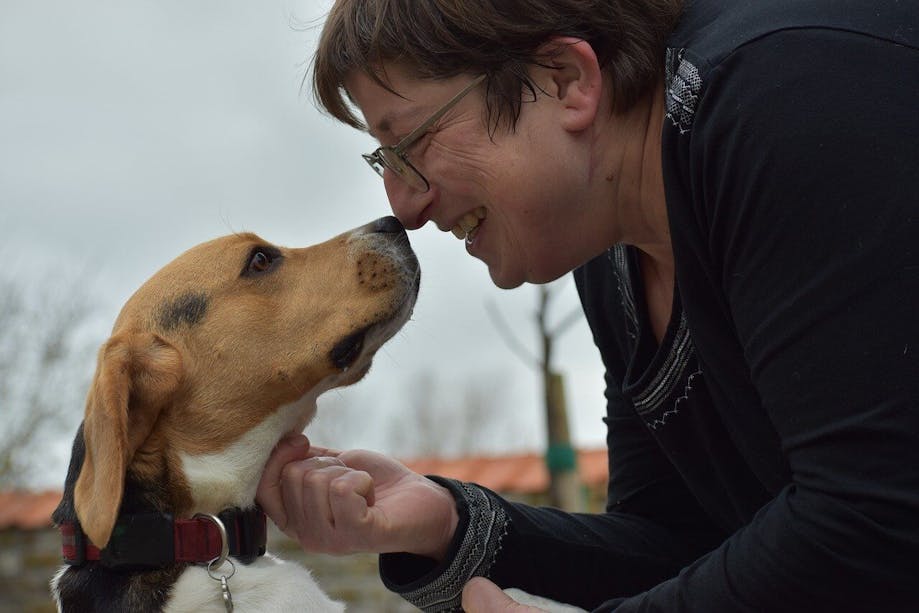 Woman smiling nose-to-nose with her dog