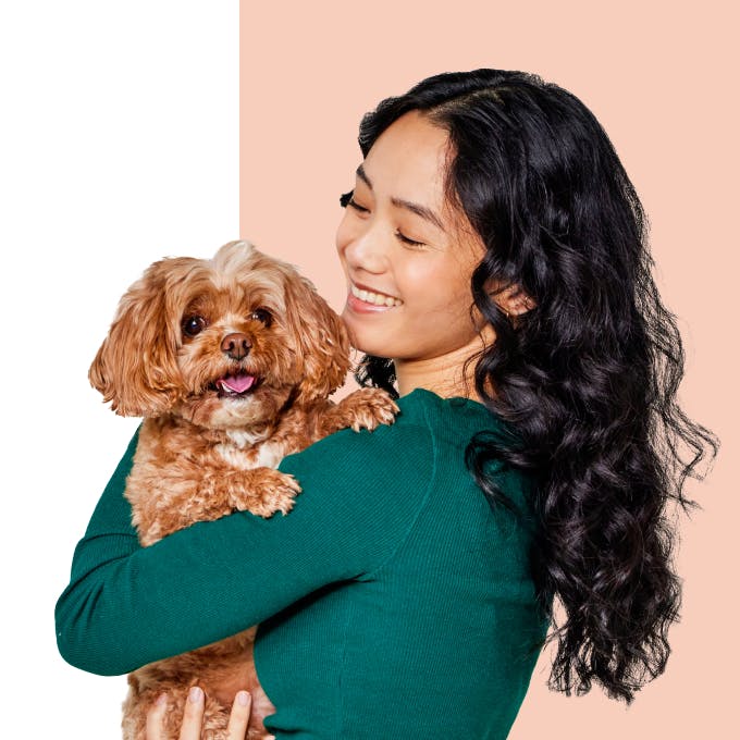 Woman hugging brown fluffy dog