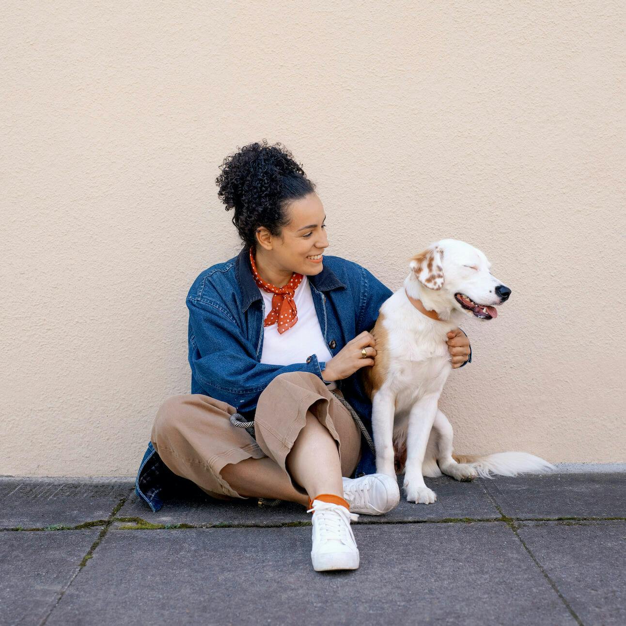 Smiling woman sitting with dog together