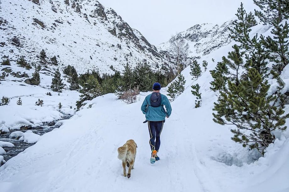 Man running in the winter weather with his dog