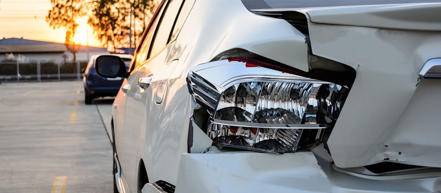 Damaged rear taillight on white vehicle