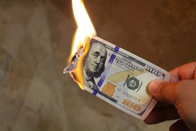 A burning 100 dollar bill