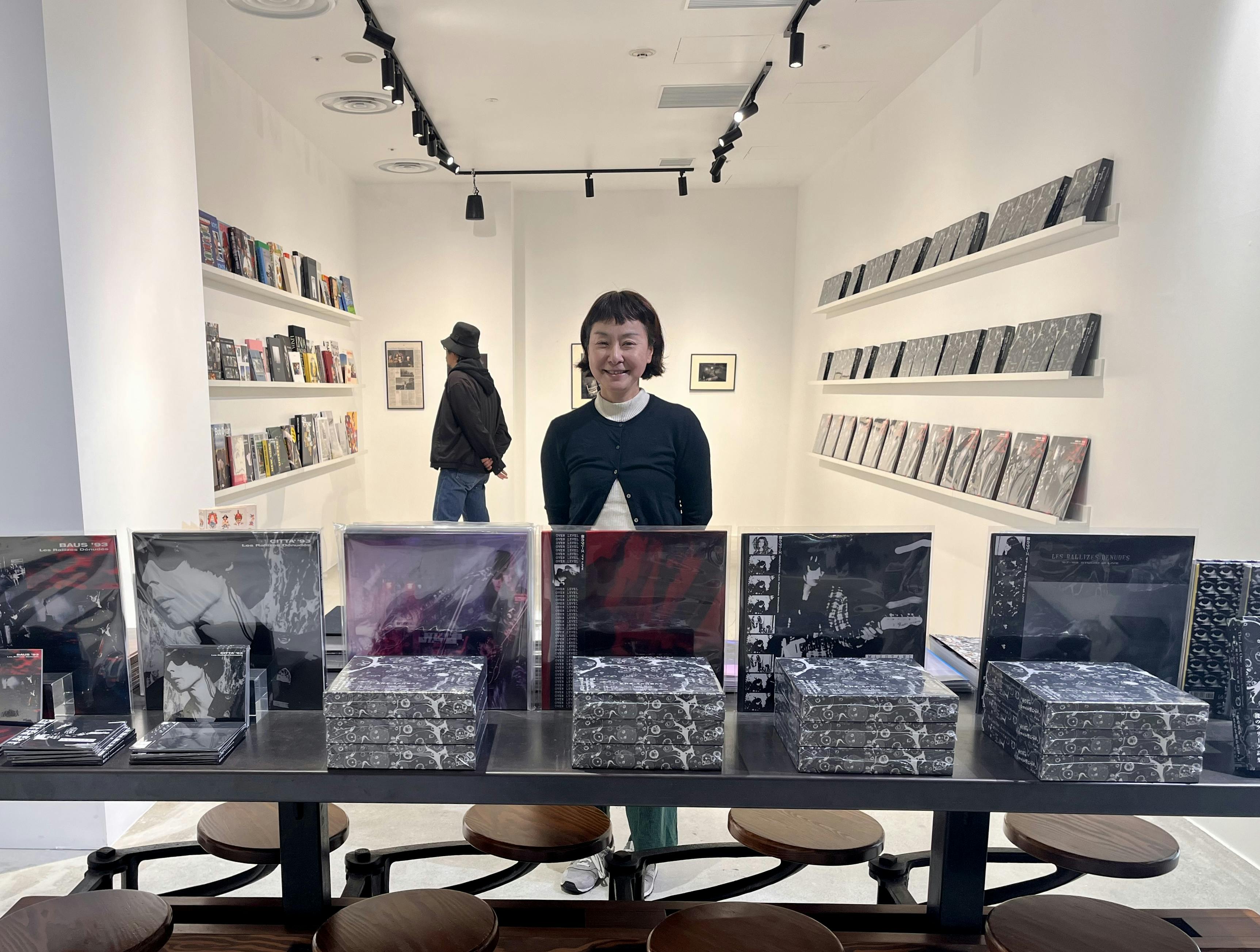 Ruriko Behind a Table with Records