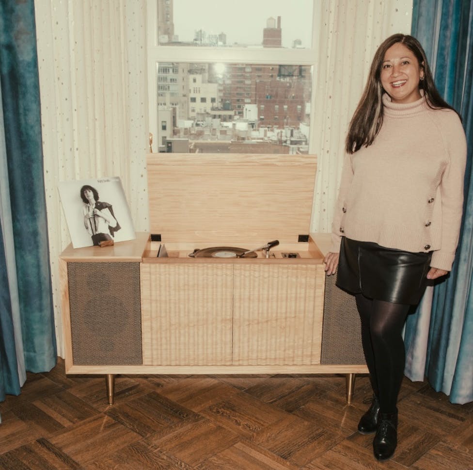 Debra standing next to console