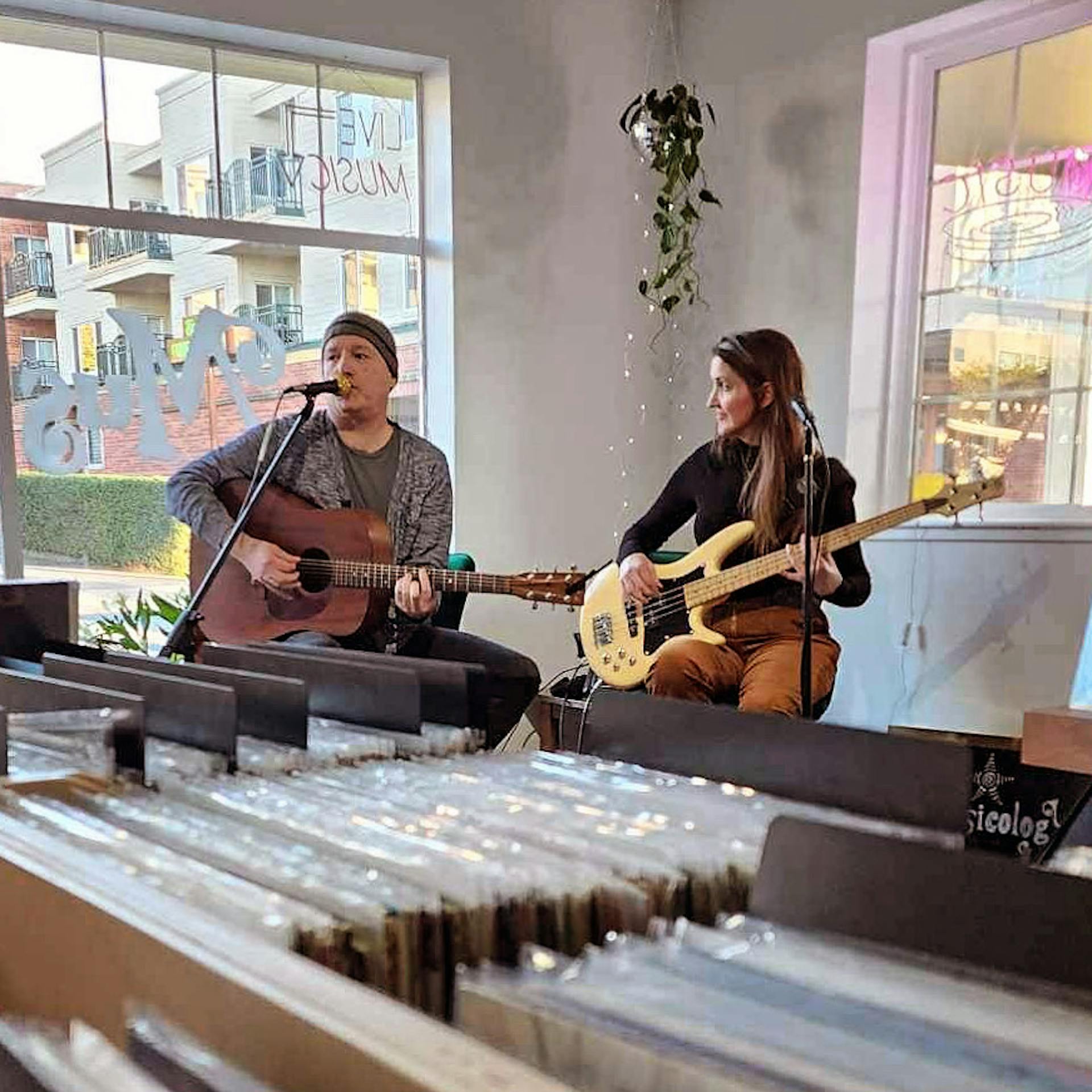 Rachel playing bass guitar at the record store