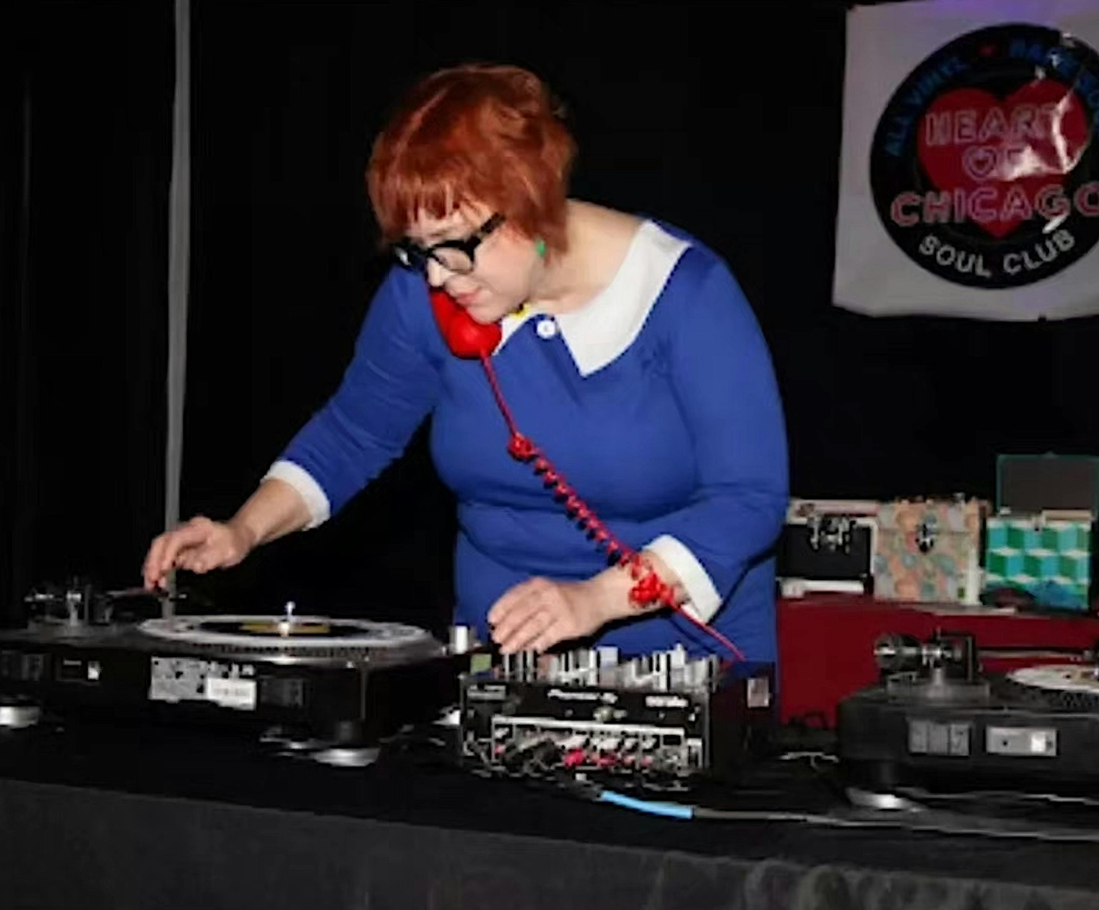 Katja DJ'ing in a blue dress