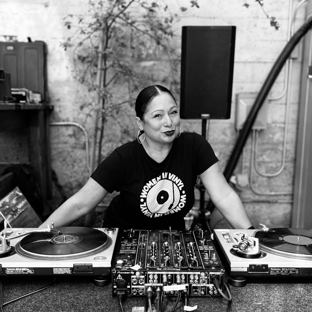 Portrait of Susana at DJ set up black and white