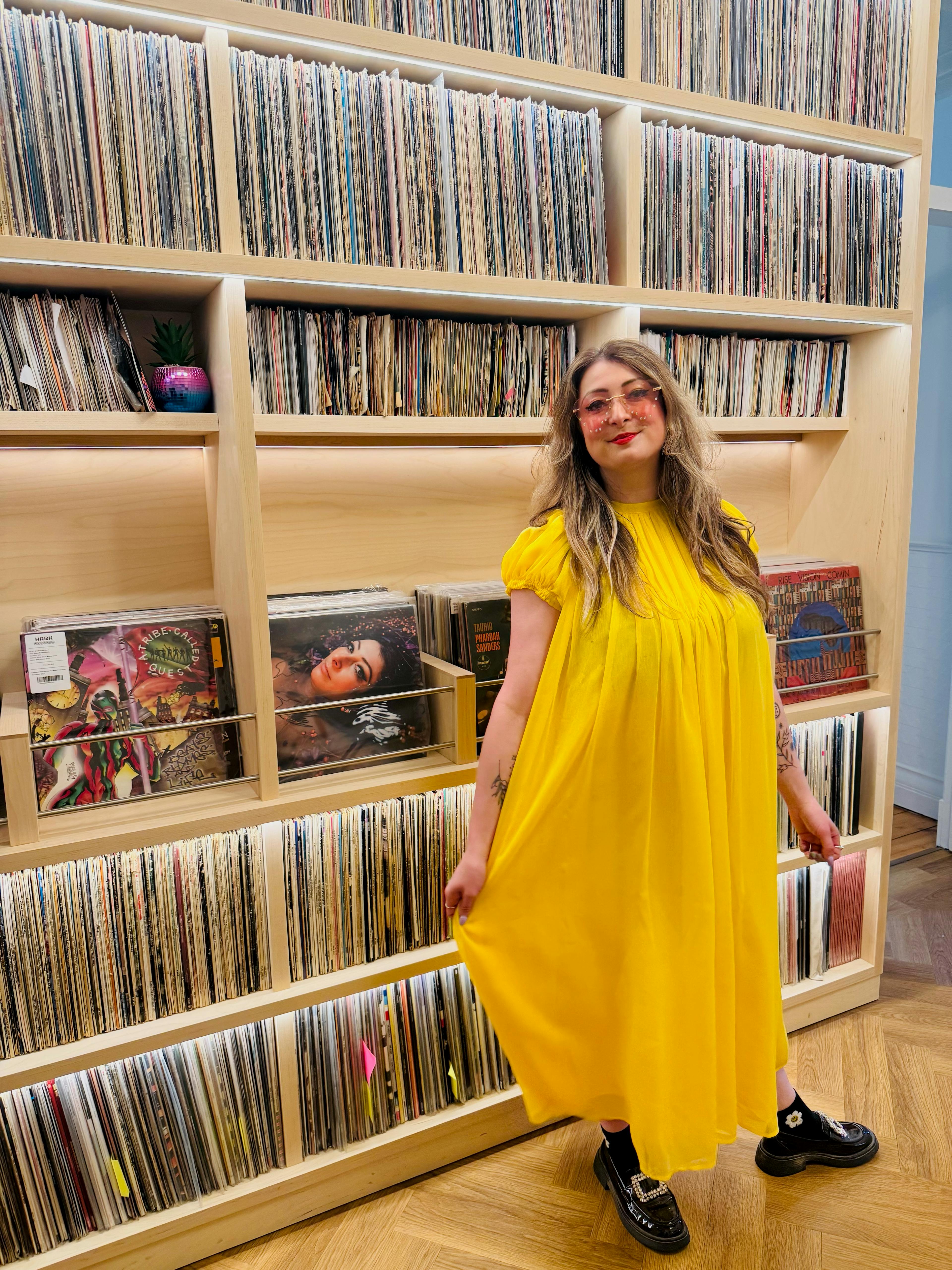 Rebecca Vasmant in front of her record collection
