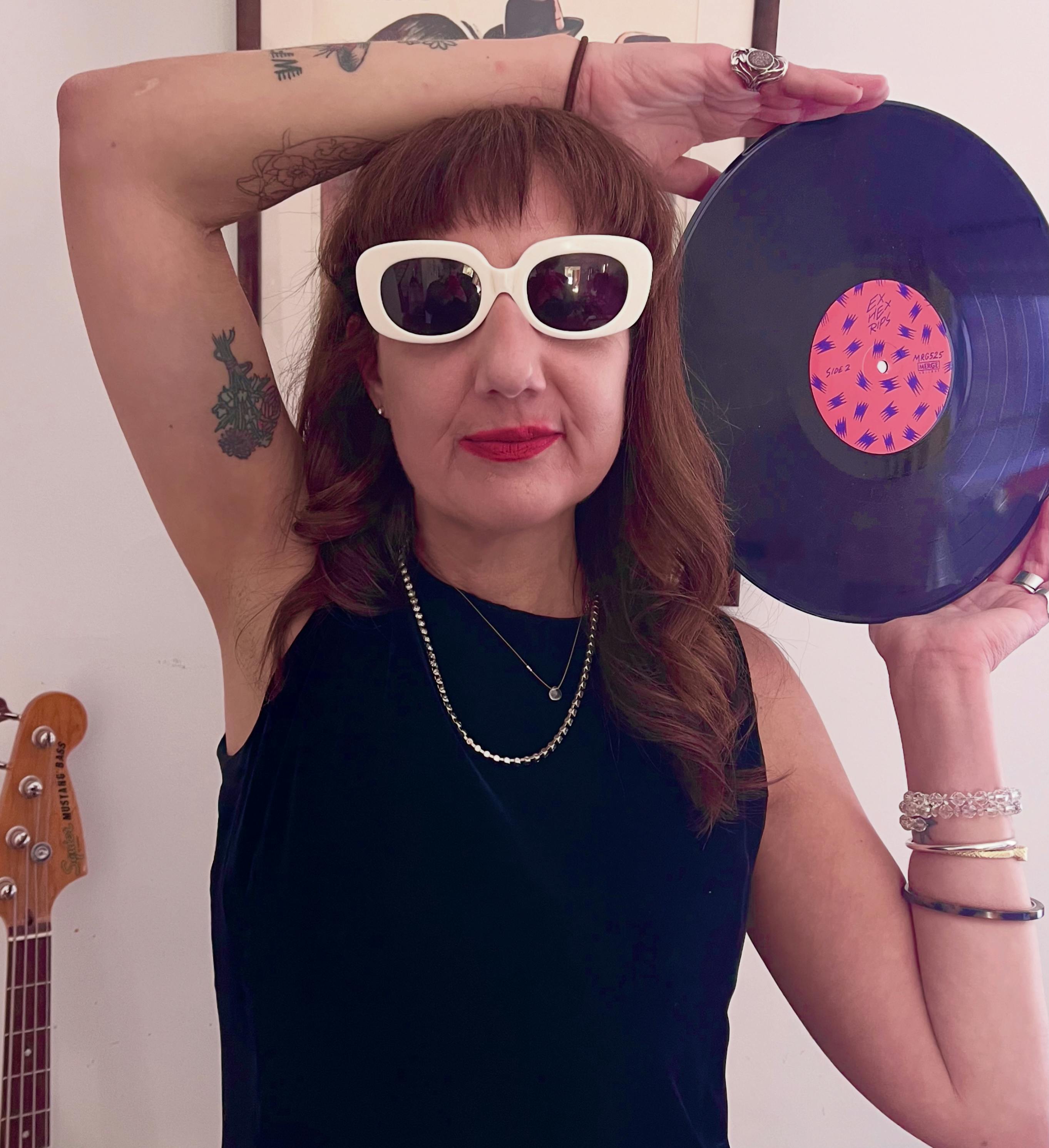Portrait of Nancy holding a purple record