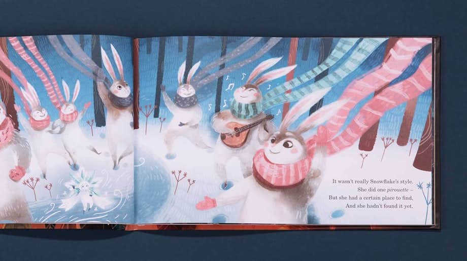 A double spread of a page in The Christmas Snowflake book whereby there are 7 rabbits surrounding the snowflake