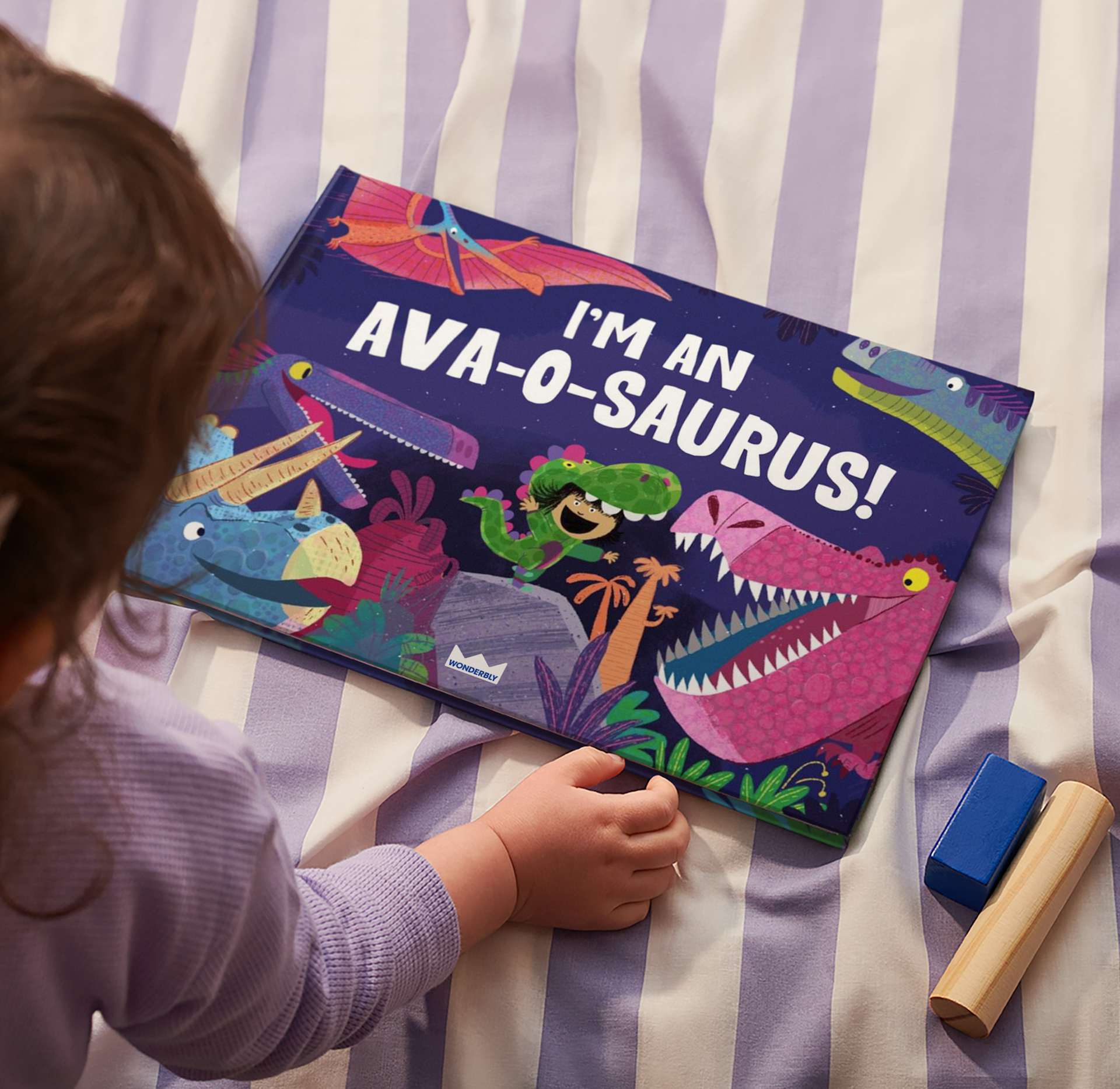 little girl reading book on bed