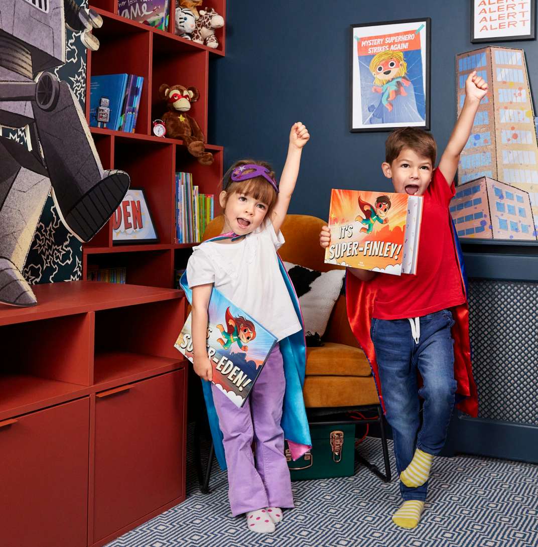 Two children holding personalised books