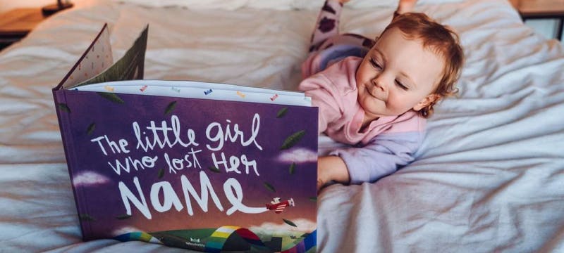 little girl reading Lost My Name