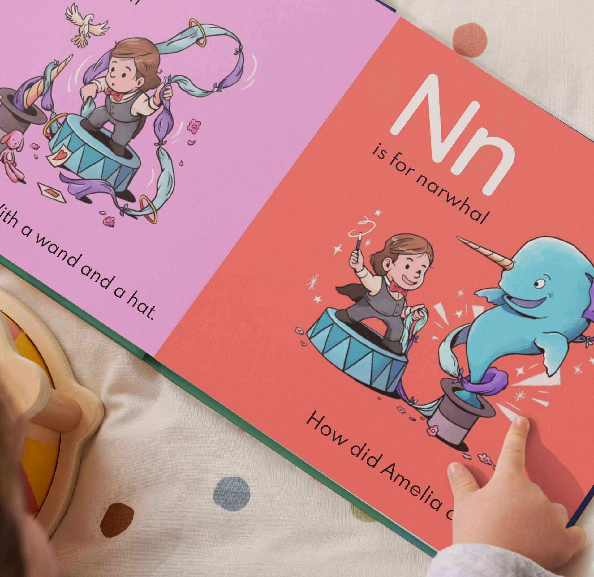 open page of abc book with child pointing at the book