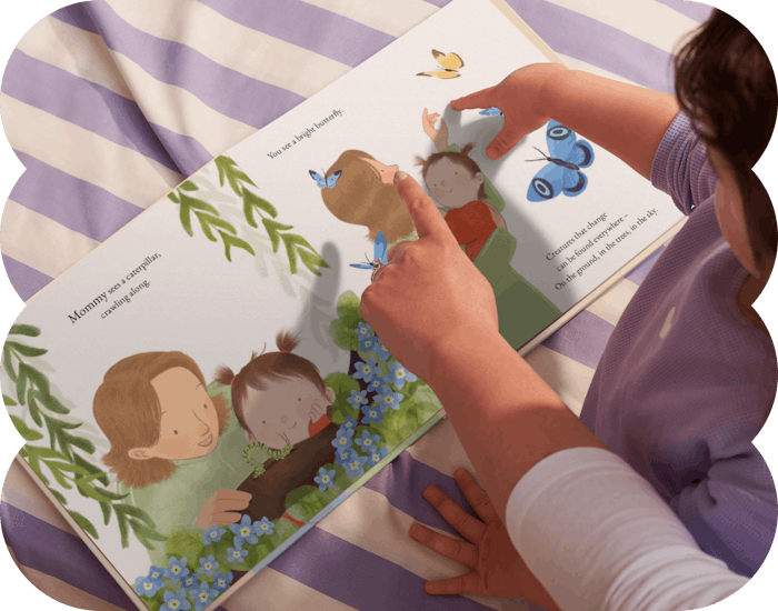 child pointing at personalised book