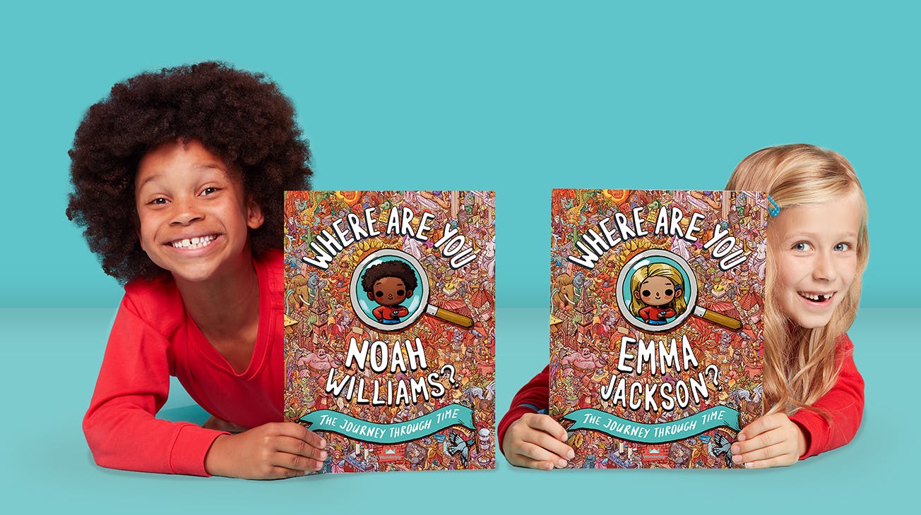 A boy and girl holding personalised copies of Where Are You...? The Journey Through Time
