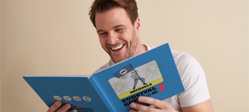 man reading survival guide book