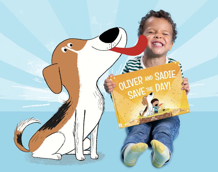 Little boy holding the book and interacting with cartoon dog