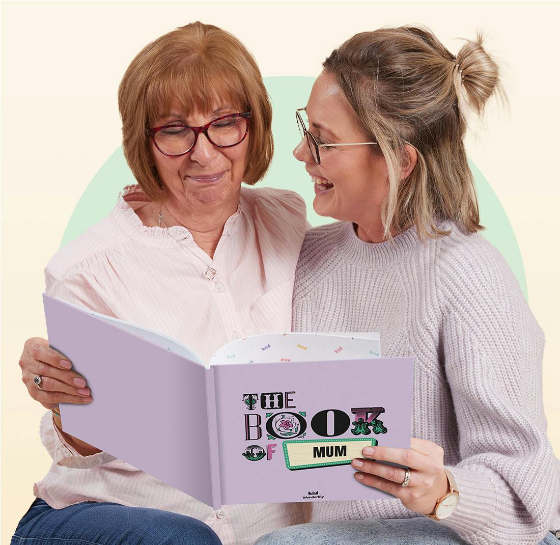 A mother and her daughter reading the book