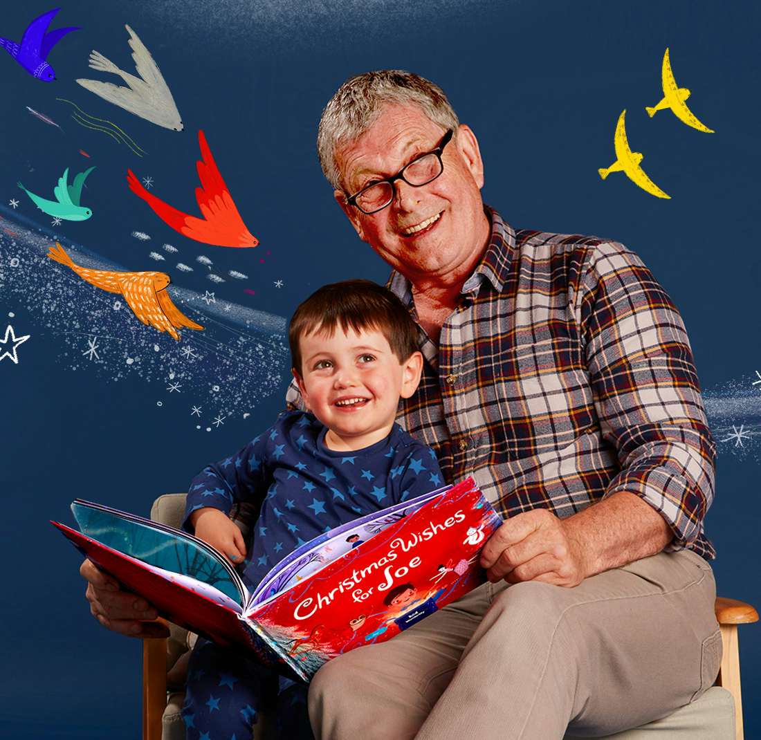 Grandad and grandson reading Christmas Wishes For You