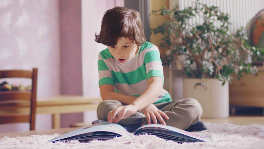 Boy reading a Lost My Name book