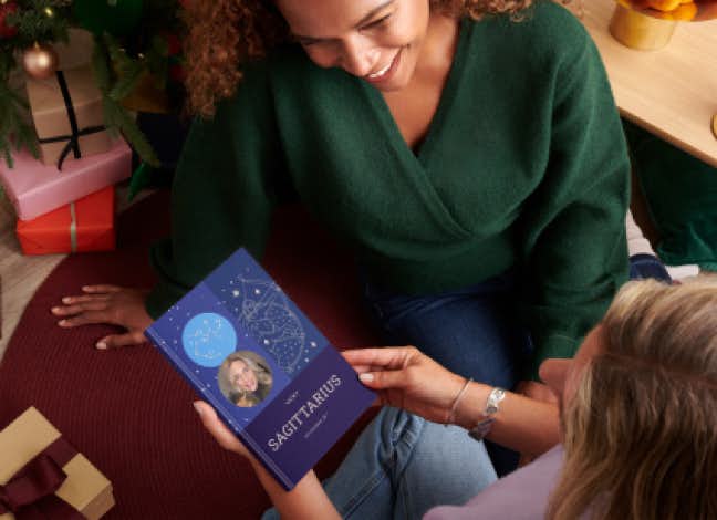 women holding astrology book