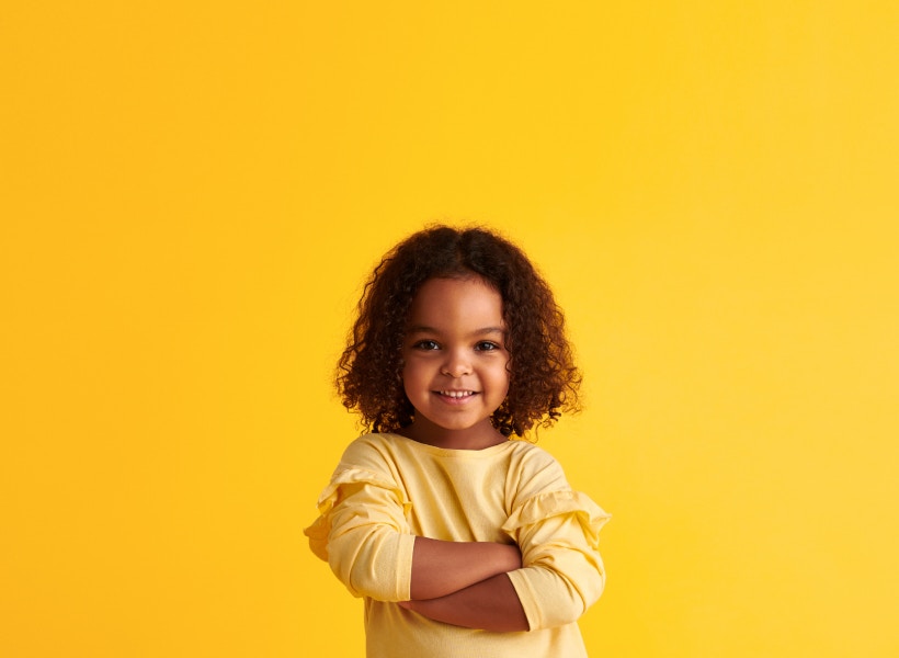 yellow background with child smiling