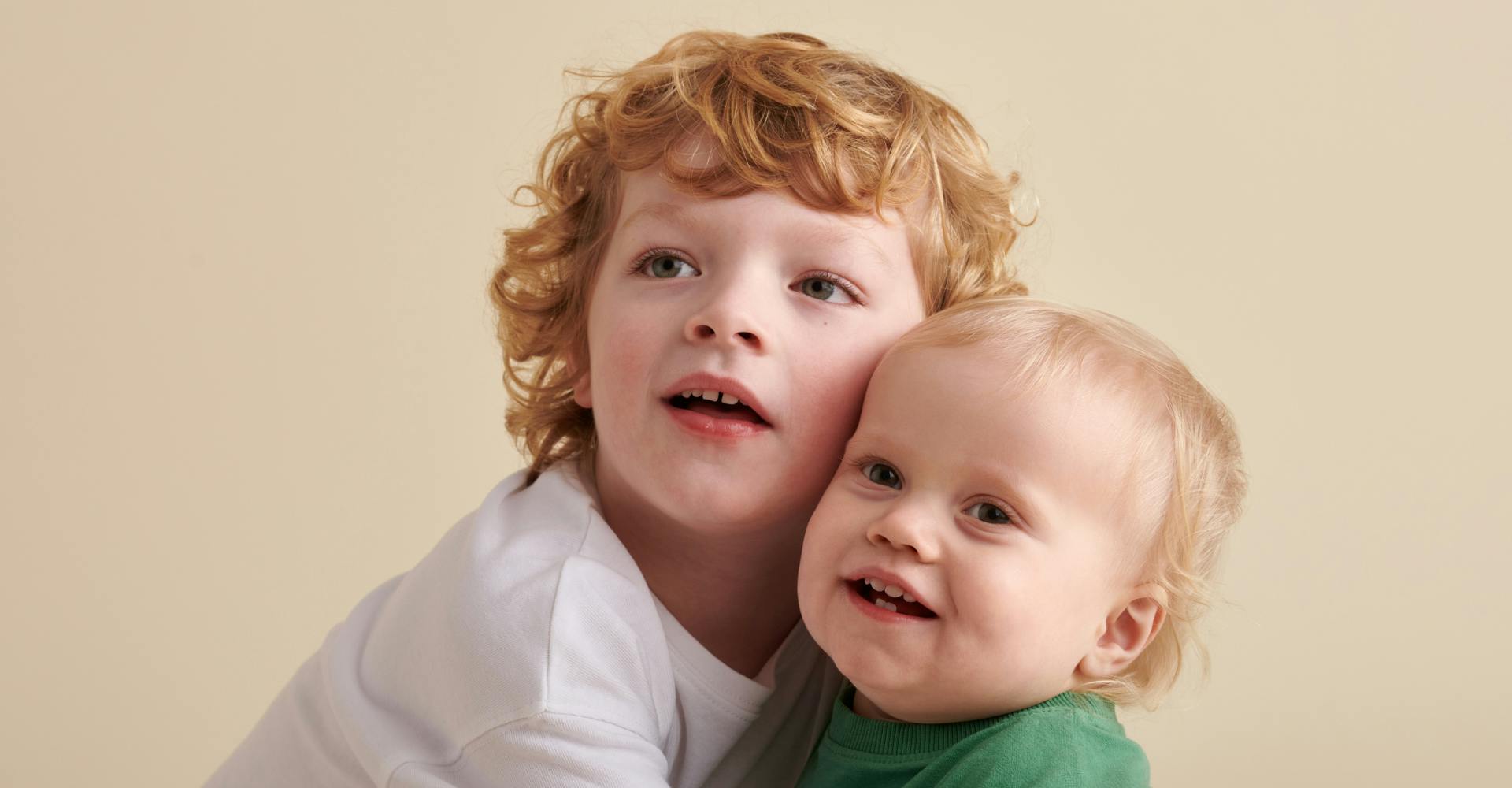child and baby hugging