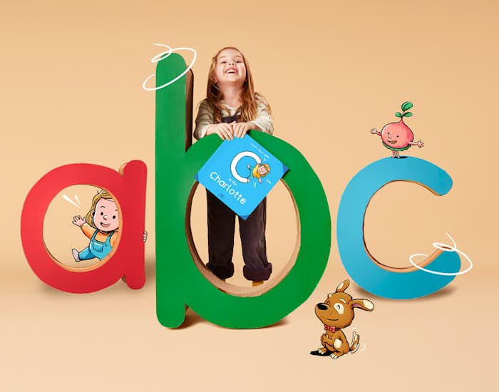 A little girl holding her personalized copy of ABC for You