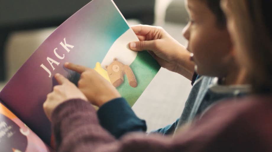 Mother and child reading the book, lost my name, together
