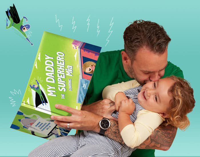 Father and daughter reading My Daddy The Superhero together