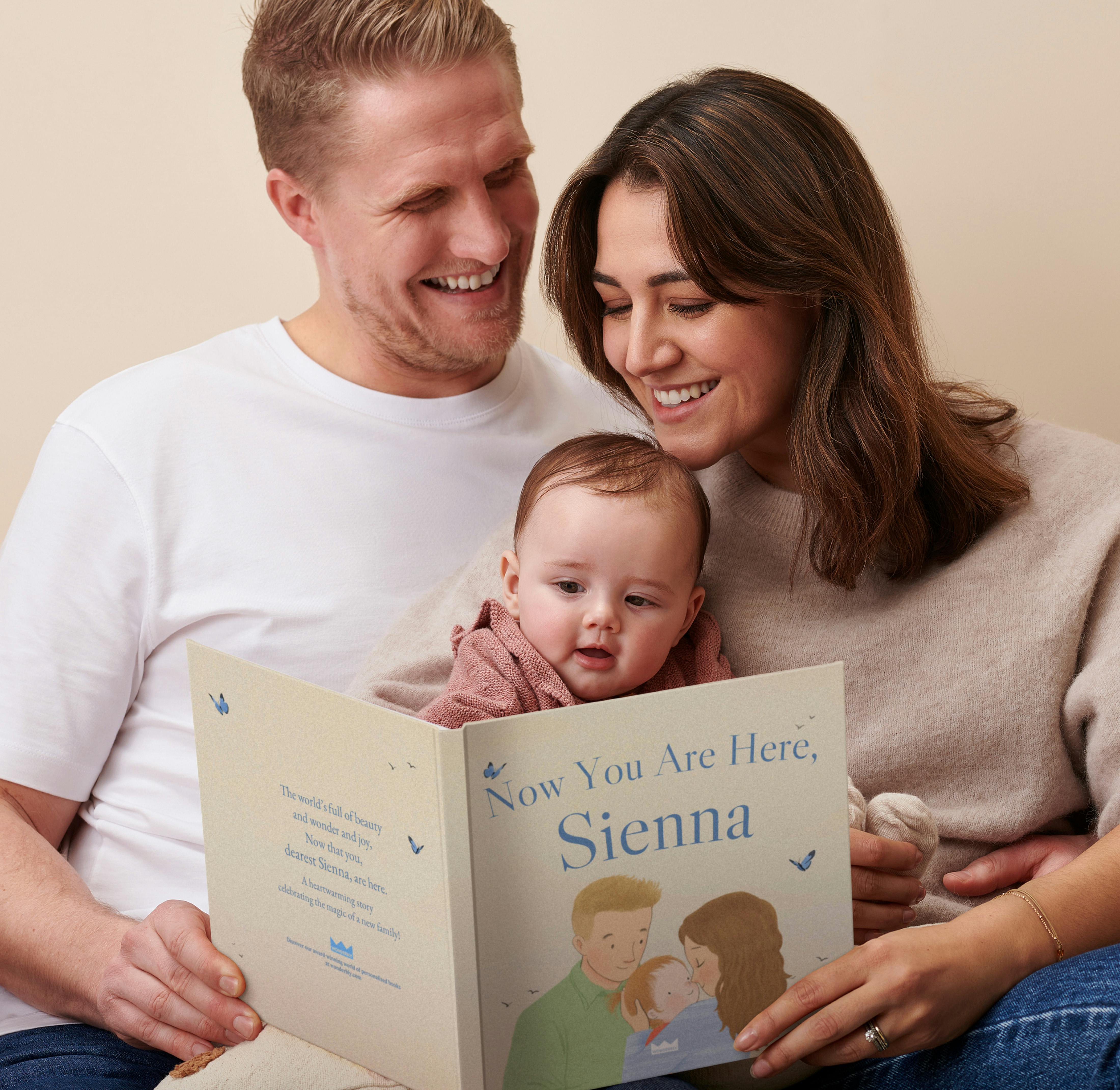mother, father and child reading personalised book