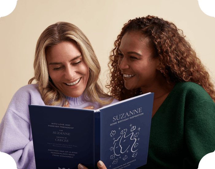 Two women reading their friendship book together