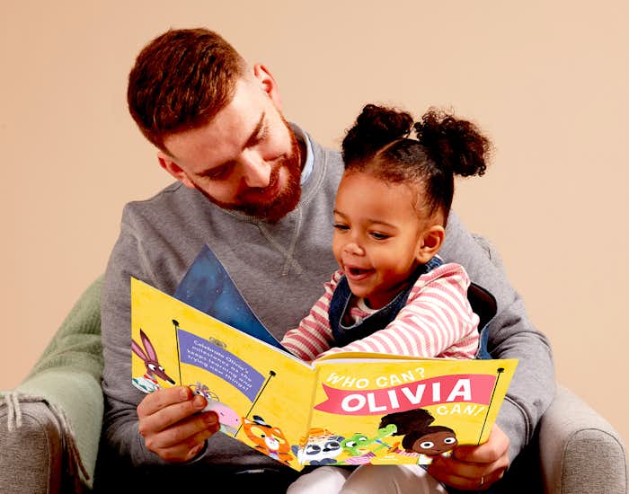 Father and child reading Who Can? You Can!