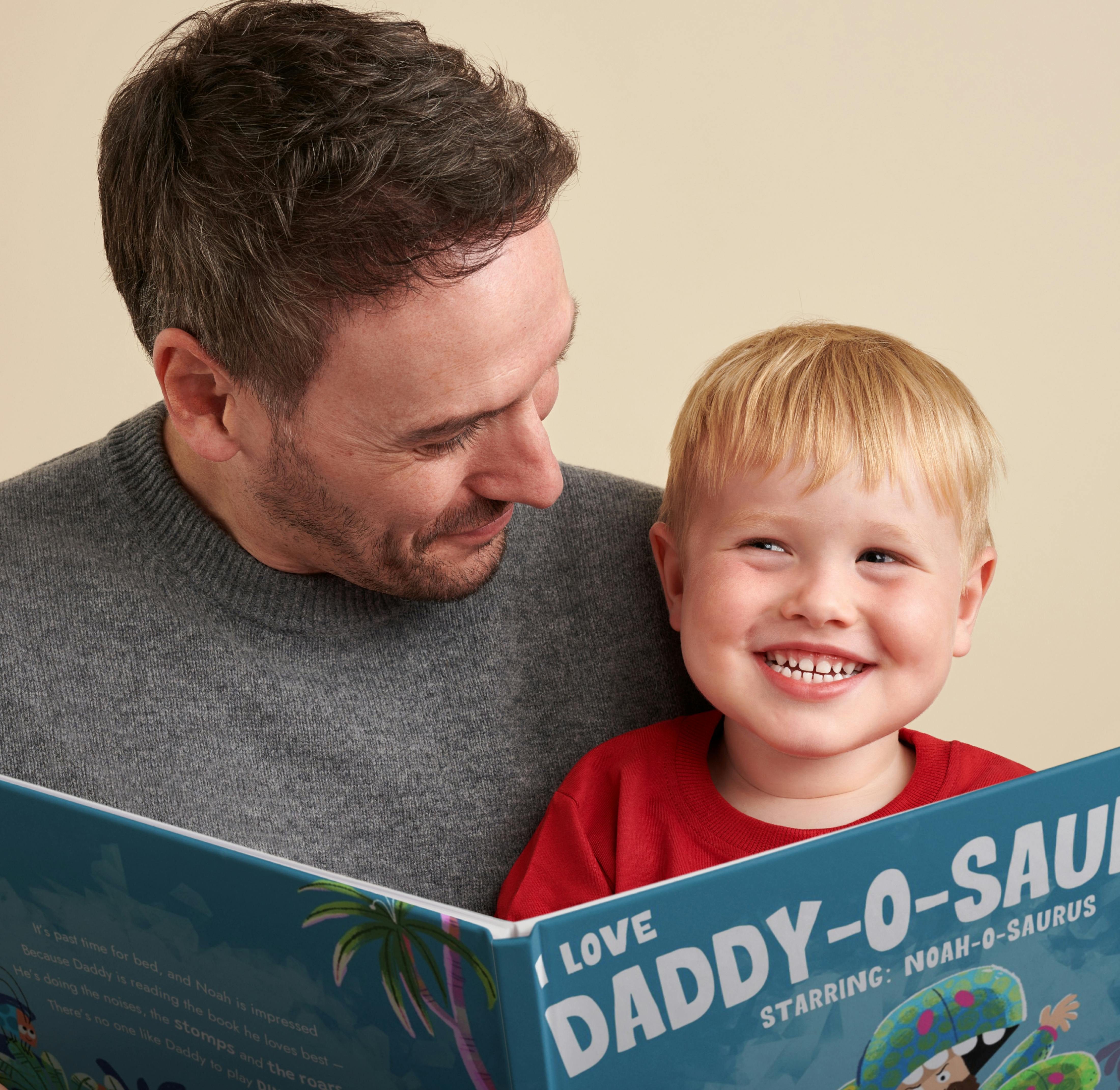A child and father reading the personalised book