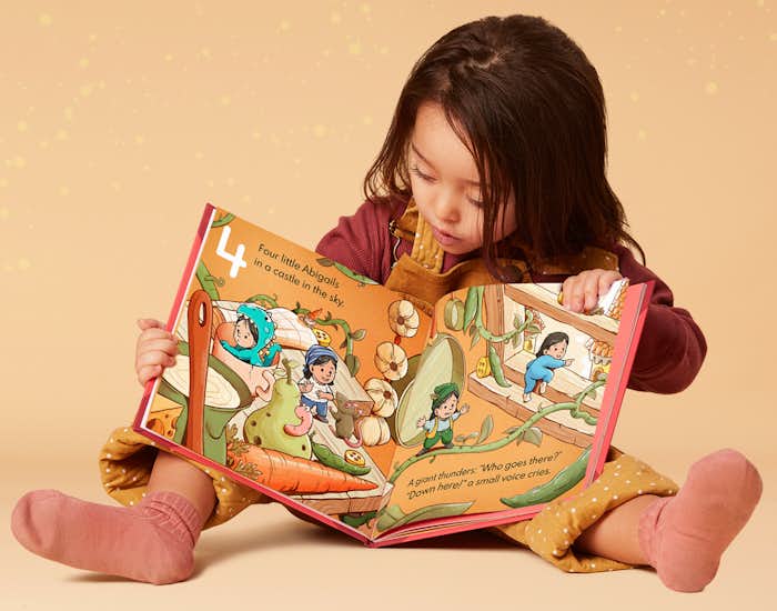 Little girl reading 10 Little Yous