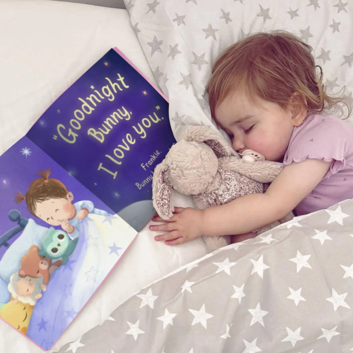 Child sleeping next to her personalised book
