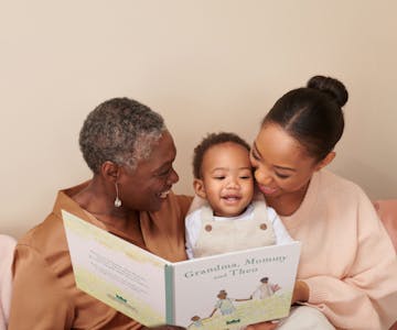 grandma, mother and child reading personalised book
