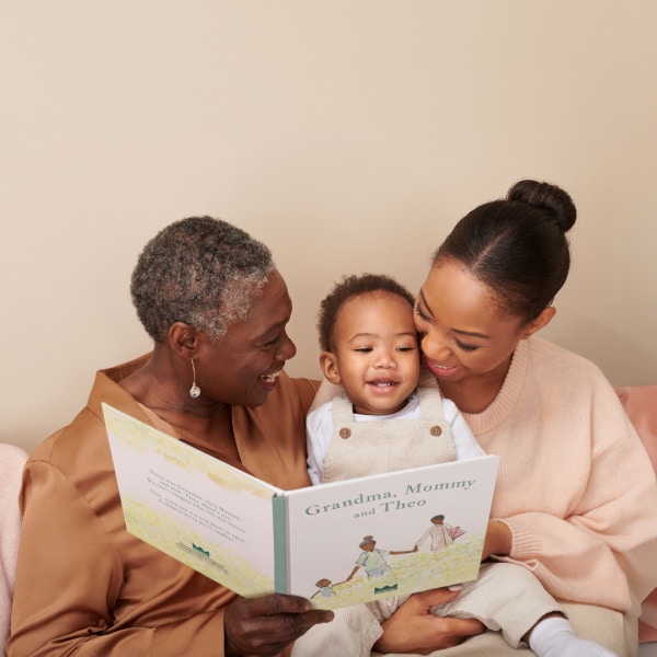 grandma, mother and child reading personalised book