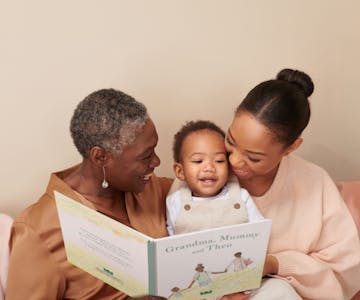 grandma, mother and child reading personalised book