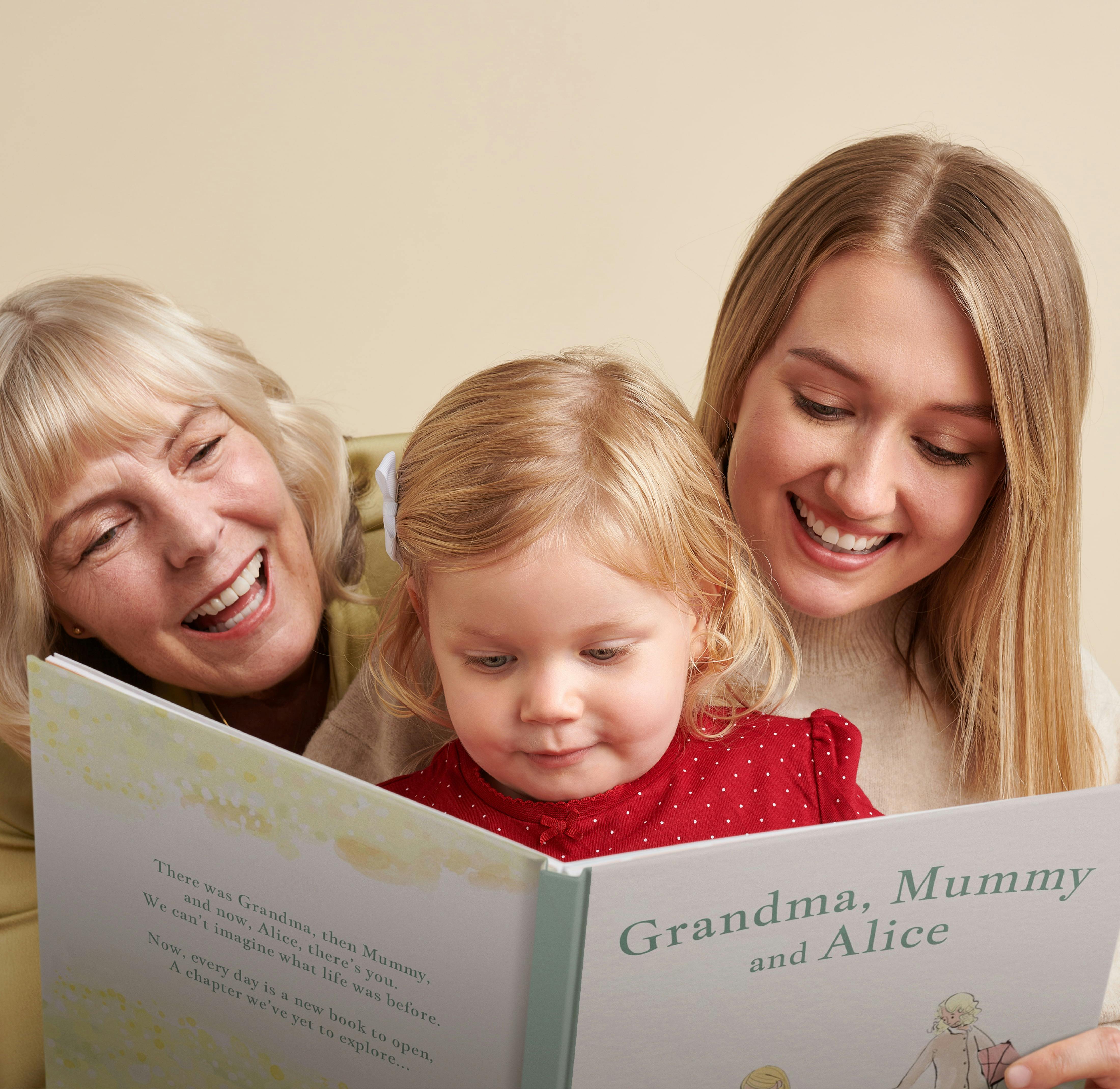 grandma, mother and child reading personalised book