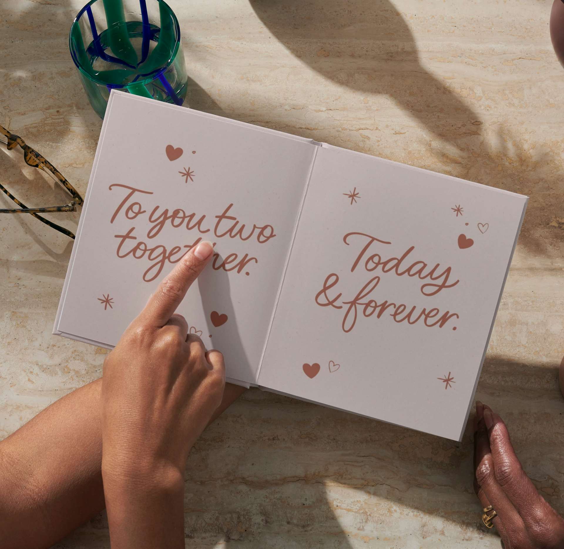 Two hands holding the open personalised book