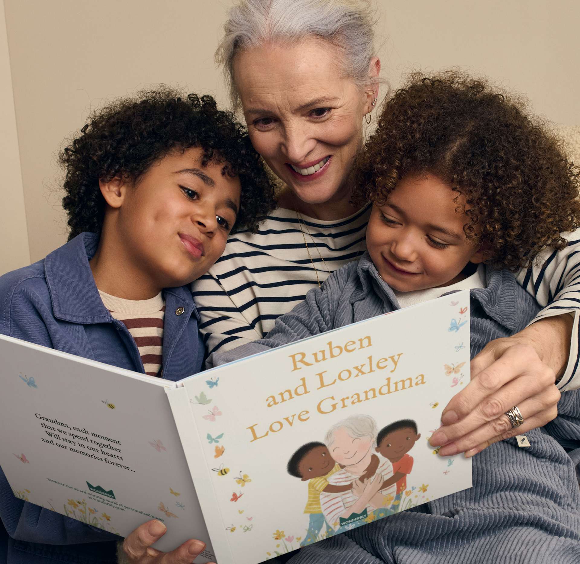 Grandmother and grandchildren reading personalised book