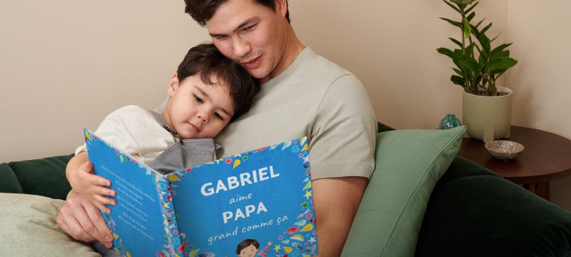un enfant et son père lisant le livre personnalisé