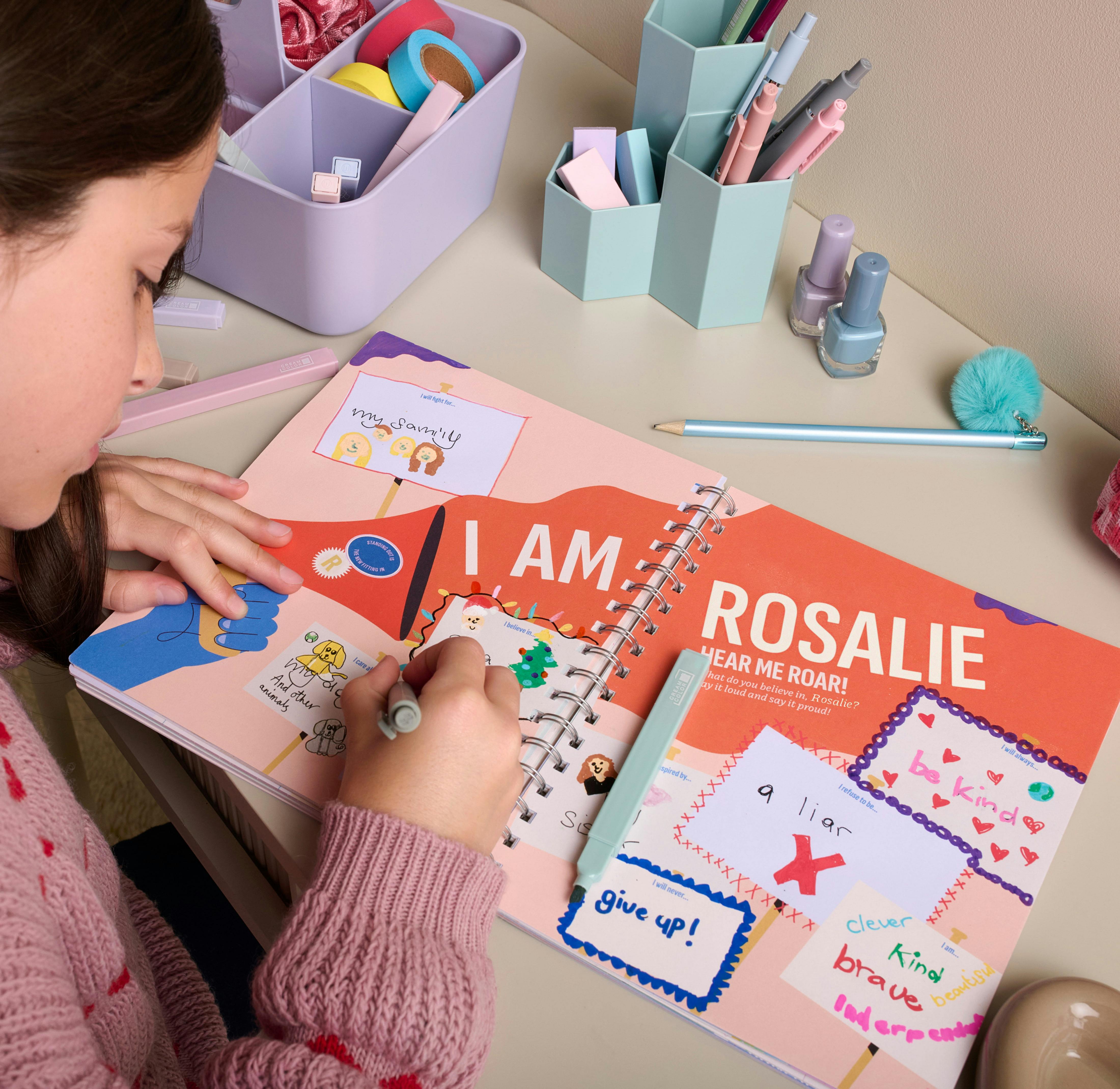 child writing in personalised journal book