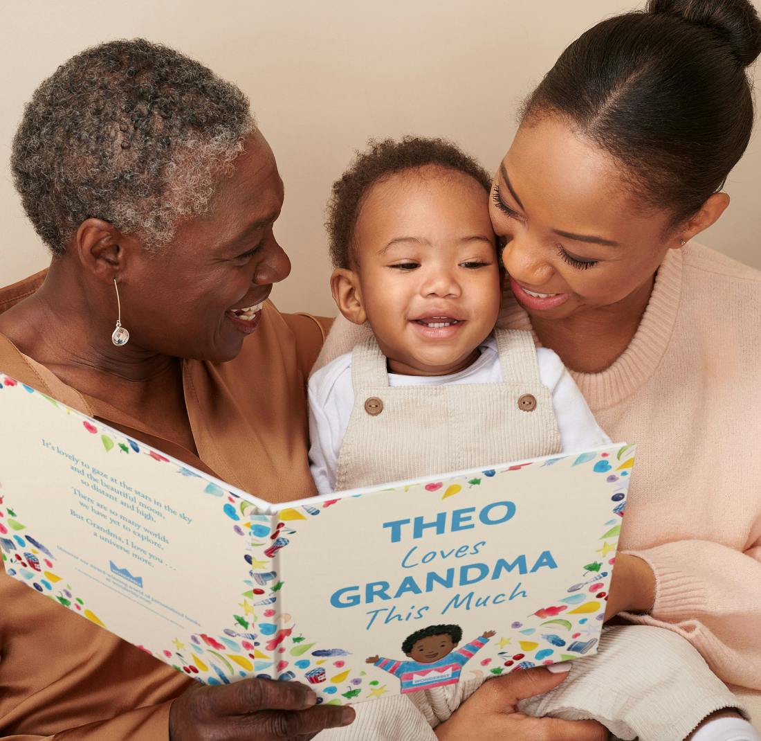 grandmother, mother and child reading personalised book