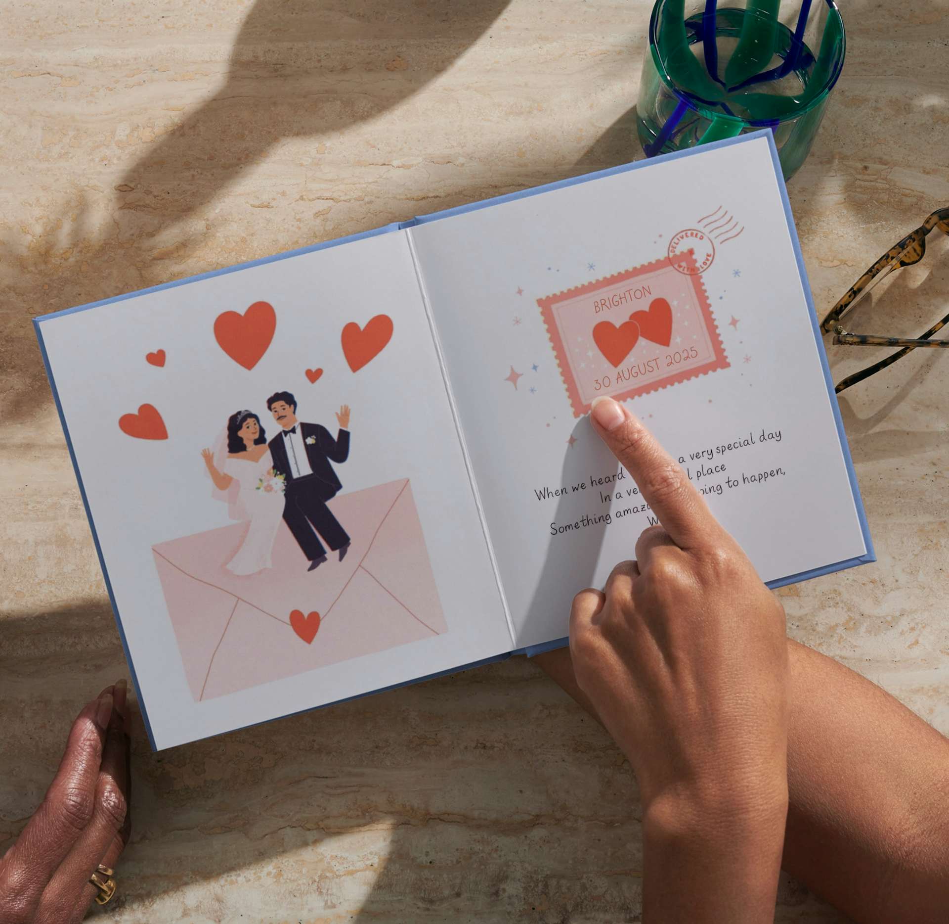 Two hands holding the open personalised book