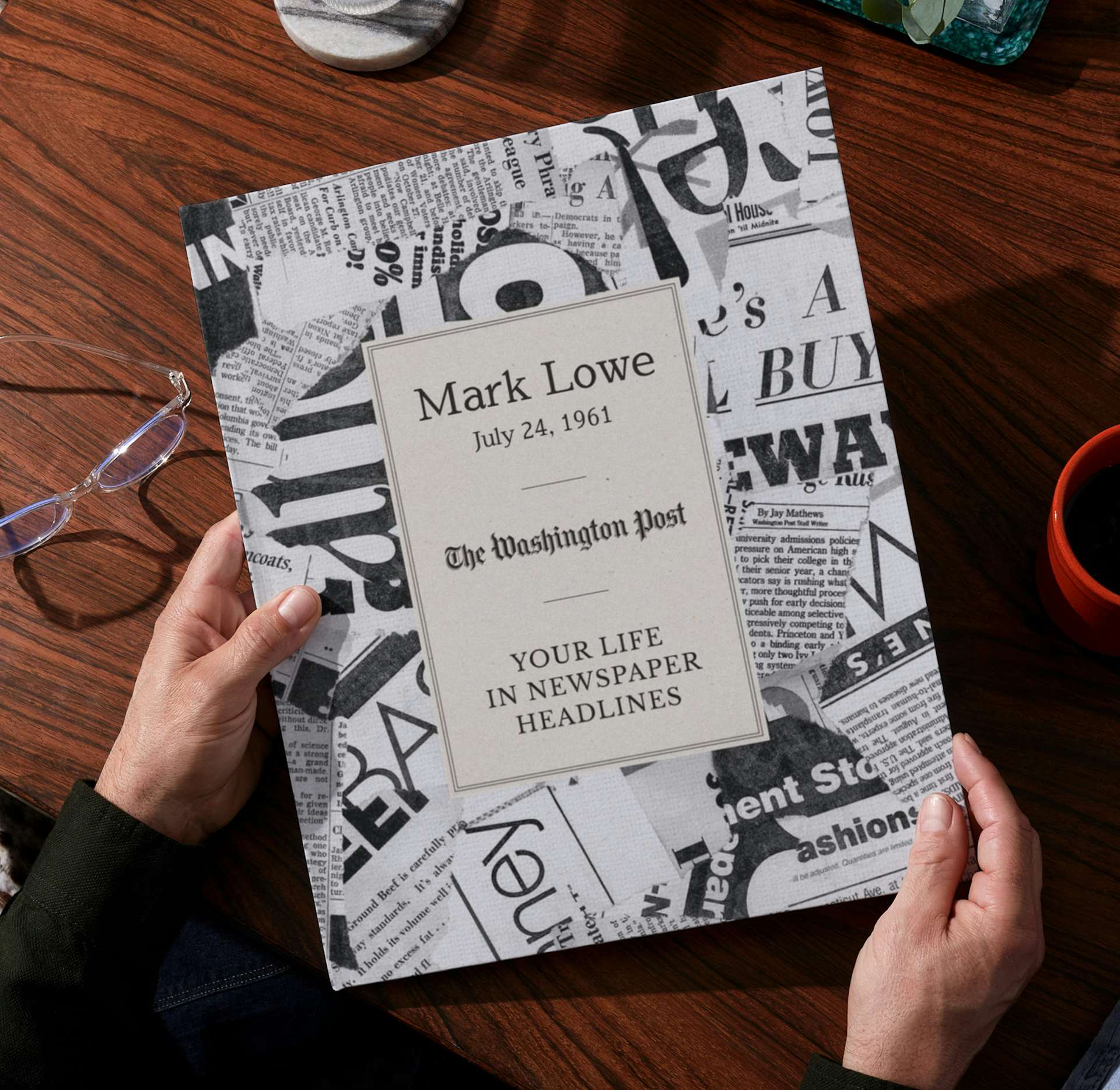 Two hands holding the open personalised book