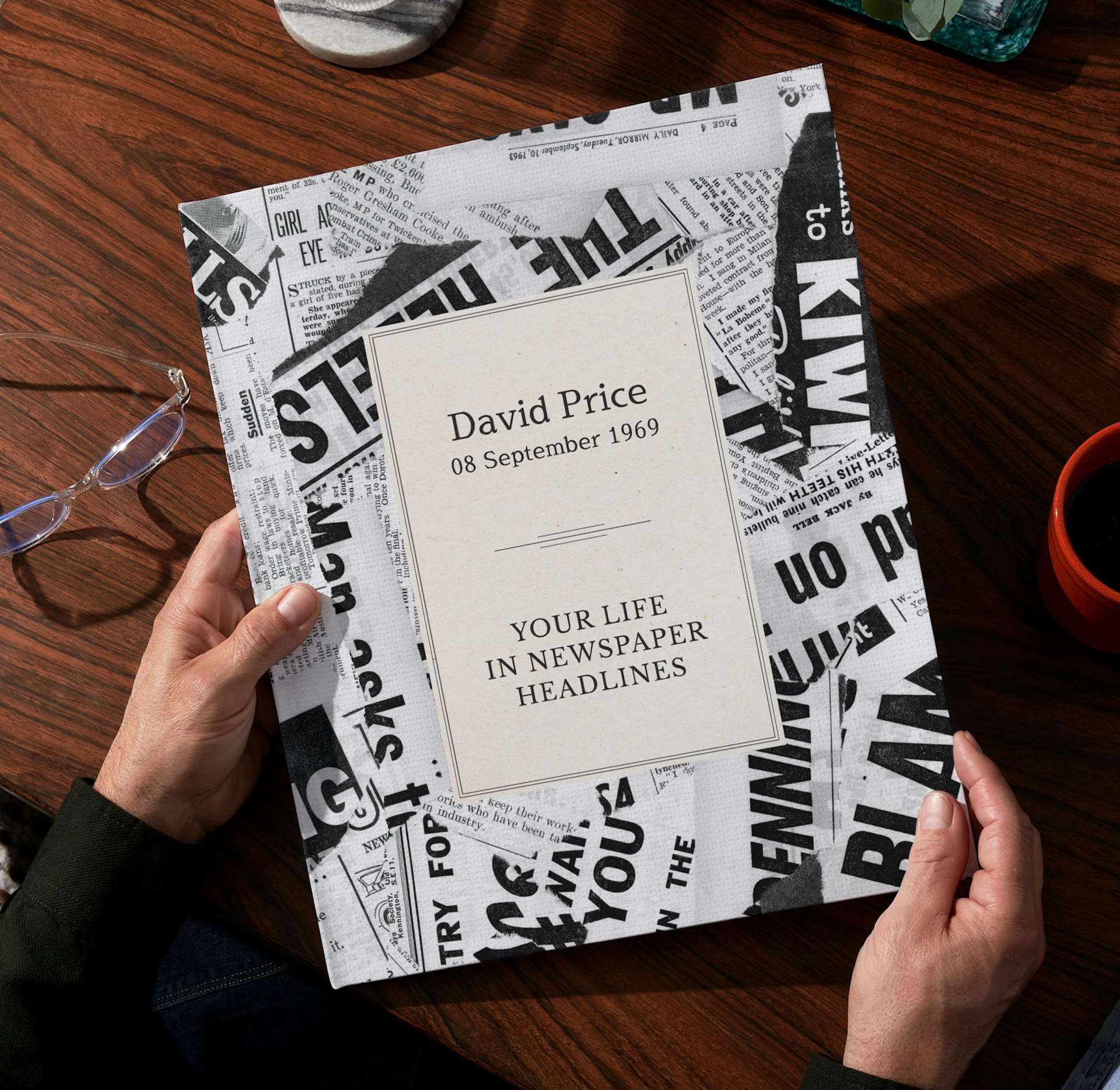 Two hands holding the newspaper book