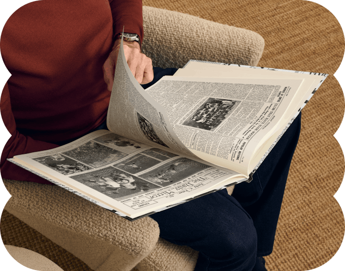 an adult reading the newspaper book pages